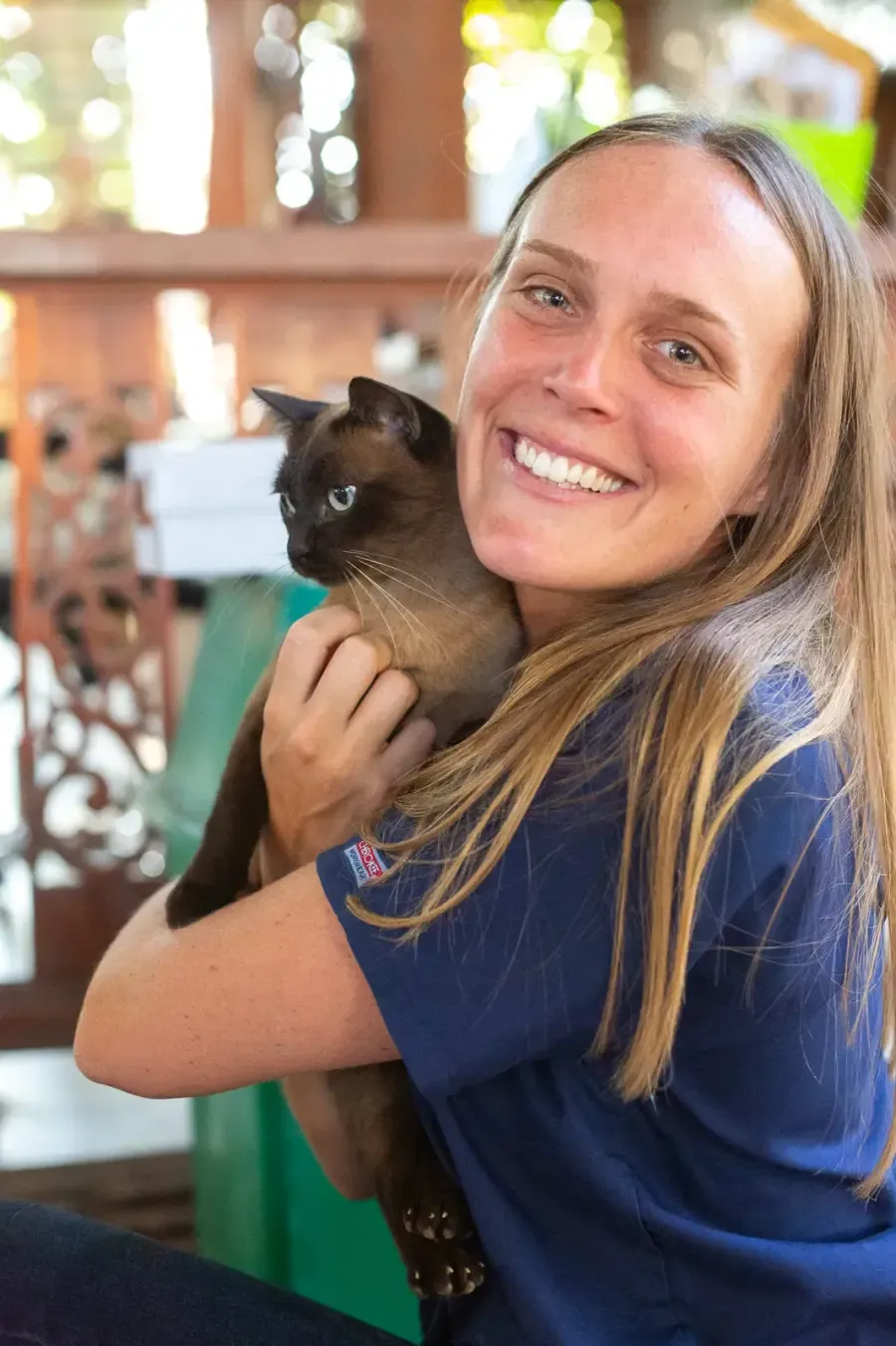 Chloe smiling, holding a cat
