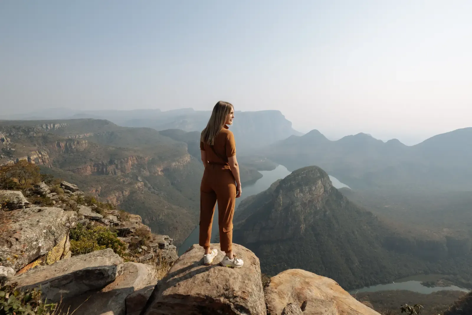 Chloe looking out over a river canyon from a rocky ridge