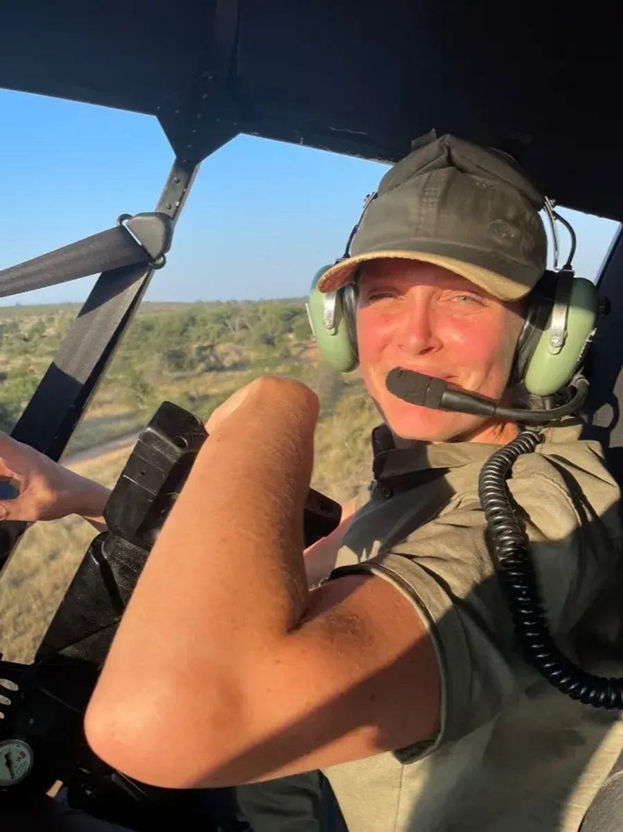 Chloe in a helicopter headset during a darting flight
